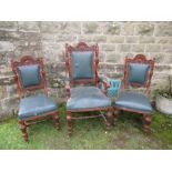 An Edwardian oak open arm chair together with two matching single chairs