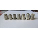 Seven silver thimbles, all hallmarked, two by James Walker, one in a leather covered case