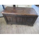 An antique oak coffer with 3 fielded panels to the front, width 49.5ins, height 26ins, depth 23ins