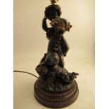 A Bronze and gilt mounted table lamp formed as Putti holding a basket raised on a beaded marble base