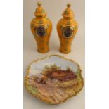 A pair of Royal Worcester covered vases, the reserve panel decorated in the Art Deco style with a