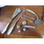 A collection of silver items, to include a button hock, show horn, bobbin case, patch box thimbles