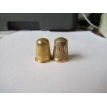 A 15ct gold thimble, weight 6.5g, together with a 9ct gold thimble, weight 3.3g