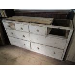 A distressed painted pine chest of drawers width 73.1ins, height 40ins, depth 24ins, together with a