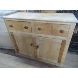 A large pine chest, fitted with two short drawers over cupboards  width 58.5ins height 47ins depth
