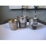Three silver plated shot cups, Just a Thimble Full, together with two acorn thimble holders and