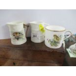 Two Royal Worcester barrel moulded jugs, one decorated with a Goldfinch by Powell, together with a