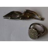 A silver brooch, formed as a stork in flight, together with a silver ring set with paste stones