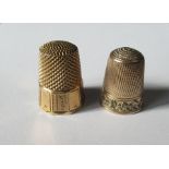 Two gold coloured thimbles, both unmarked