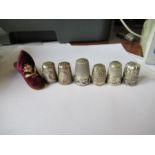 Six thimbles, four hallmarked sliver, one decorated with mistletoe, two with animals, together