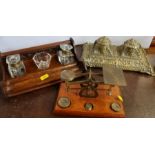 A brass double inkwell, together with an oak inkwell with glass bottles and a set of postage scales,