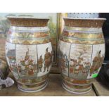 A pair of Satsuma pottery vases, decorated with panels of figures, buildings and birds, height 10ins