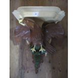 A painted wall bracket decorated with a stylized eagle af  width 21ins height 20ins