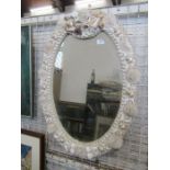 An oval mirror, the frame decorated with sea shells