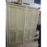 A large painted wardrobe, decorated with fielded panels, width 66ins, height 83ins, depth 38ins af