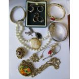 A collection of costume jewellery, to include a cameo brooch, bangles, necklaces, watch etc
