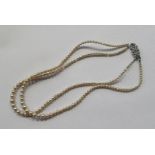 A double string bead necklace, with paste clasp