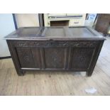 An Antique oak coffer, 3 fielded panels to the top and 3 fielded panels to side with carved