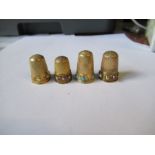 A gold coloured thimble, set with pearls, turquoise and diamonds, some stones missing, together with