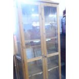 A glazed pine cabinet