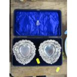 A cased pair of silver heart shaped dishes