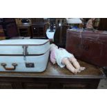 Two suitcases and a doll