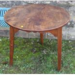 An Antique elm cricket table, with circular top, raised on three legs, diameter 28.5ibns, height