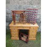 A pine desk together with a nest of tables , wine rack and magazine rack.