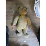 A gold plush teddy bear, with hump back, height 23ins