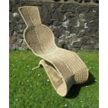 A modern seagrass and metal framed cantilever chair