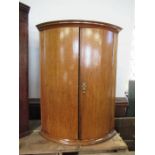 A 19th Century oak bow fronted corner cupboard. max width 25ins, height 34ins, together with a