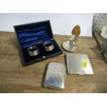 A collection of silver, to include napkin rings and cigarette cases
