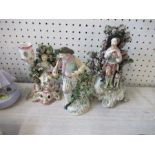 Three 19th century porcelain figures, a seated girl with flowering bush behind and sheep at her