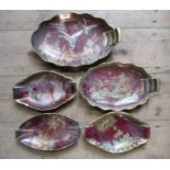 Five Carlton Ware Rouge Royal oval dishes, decorated with various patterns