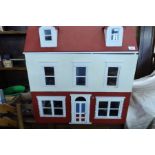 A dolls house, with a large collection of dolls house furniture, china, figures, kitchenalia etc
