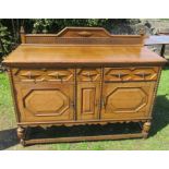 An oak sideboard, with carved decoration, fitted with drawers and cupboards, 59ins x 22.5ins, height