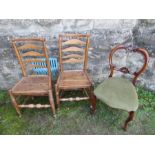 A pair of antique oak ladder back chairs together with a Victorian dining chair.