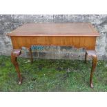 A mahogany desk, with inset leather writing surface, shaped frieze and raised on cabriole legs to