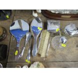 A silver dressing table set, comprising boxes, jars, brushes, hand mirror etc, all engraved with a