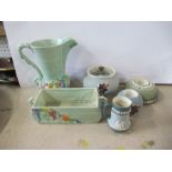 A collection of Carlton ware, to include a jug and planter, match strikers, tobacco jar with