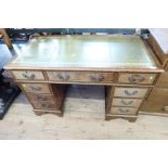 A mahogany pedestal desk, with leather inset writing surface and fitted with an arrangement of 9