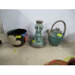 Three pieces of Studio pottery, to include a candlestick decorated with a face, marked Tom,