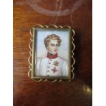 A portrait rectangular miniature, of a young officer in white jacket, signed, in gilt metal brooch
