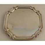 A silver salver, of shaped square form with ogee edge, raised on four feet, Sheffield 1926, weight