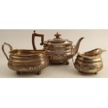 A Georgian silver three piece tea set, with gadrooned edge and lower body, each piece engraved