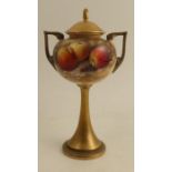 A Royal Worcester covered pedestal vase, decorated to the front with fruit to a mossy background