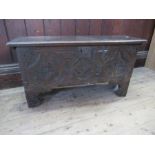 A small Antique oak coffer, with carved decoration to the front,  width 34ins, depth 11.5ins, height