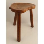 A Robert Mouseman Thompson three legged stool, with shaped seat and chamfered legs, height 14ins