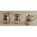Two silver baluster shaped jugs, Birmingham 1923, London 1958, weight 11oz, together with a silver