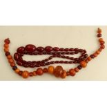 A cherry amber graduated bead necklace, weight 70.5g, together with an amber bead necklace, weight